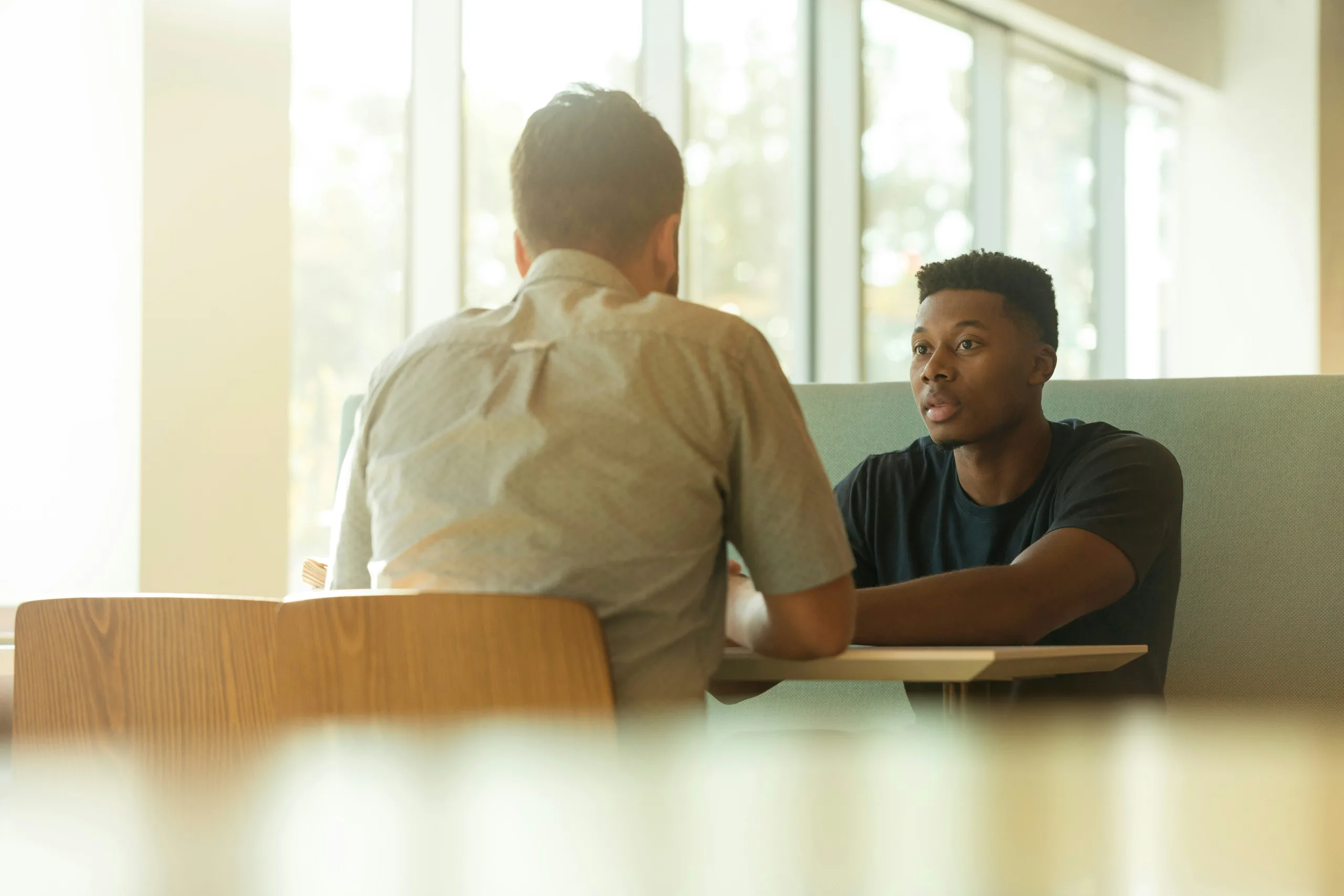 Two people talking in conversation, illustrating how people can listen and respect different perspectives without agreeing.